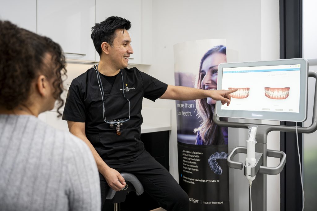 Dentist discussing scans of teeth with the patient