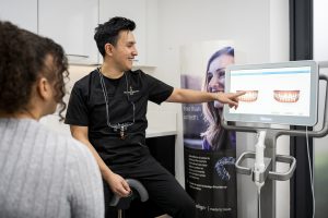 Dentist discussing scans of teeth with the patient