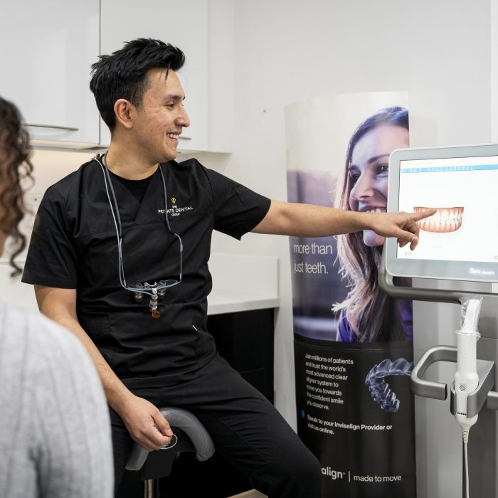 Dentist discussing scans of teeth with the patient